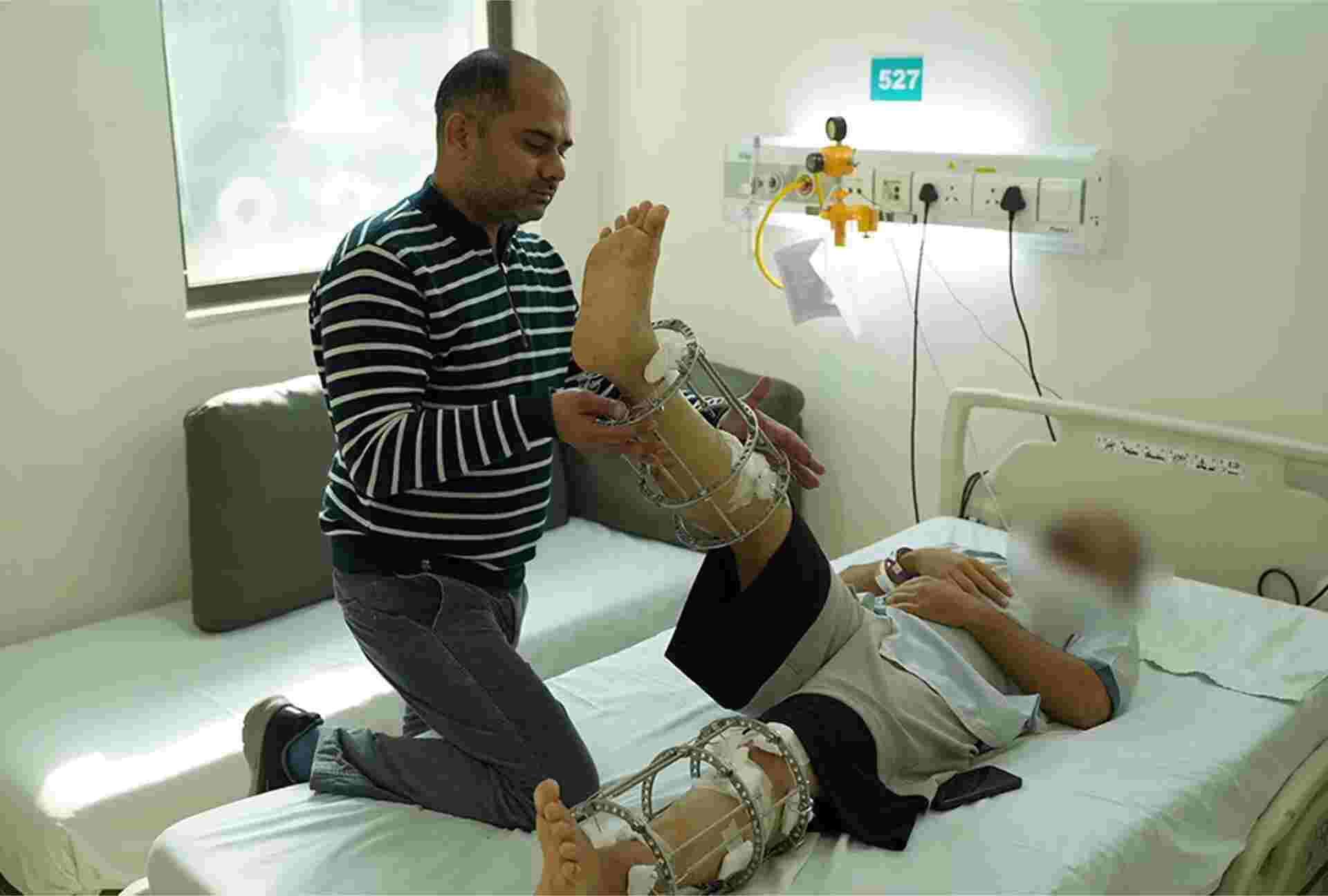 Physiotherapist assisting with leg exercises after limb lengthening procedure